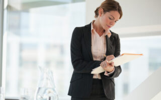 Businesswoman writing in office